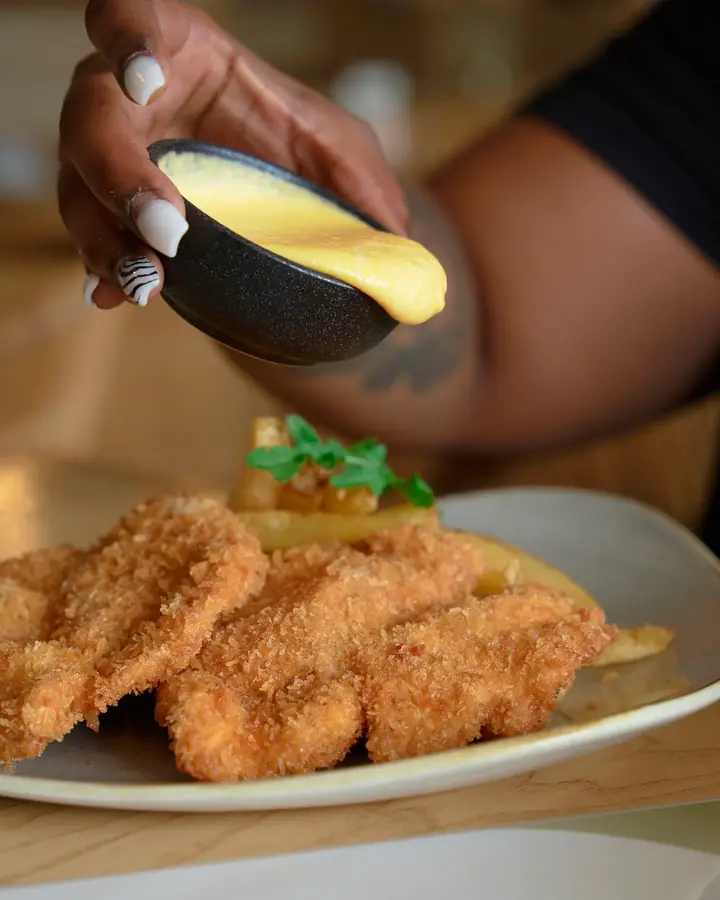 Crumbed chicken strips with chips and dipping sauce